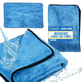 Blue microfibre large car towel shown folded with black trim, alongside a flat view of the towel and a printed product label. Water splash graphics appear around the towels on a white background.