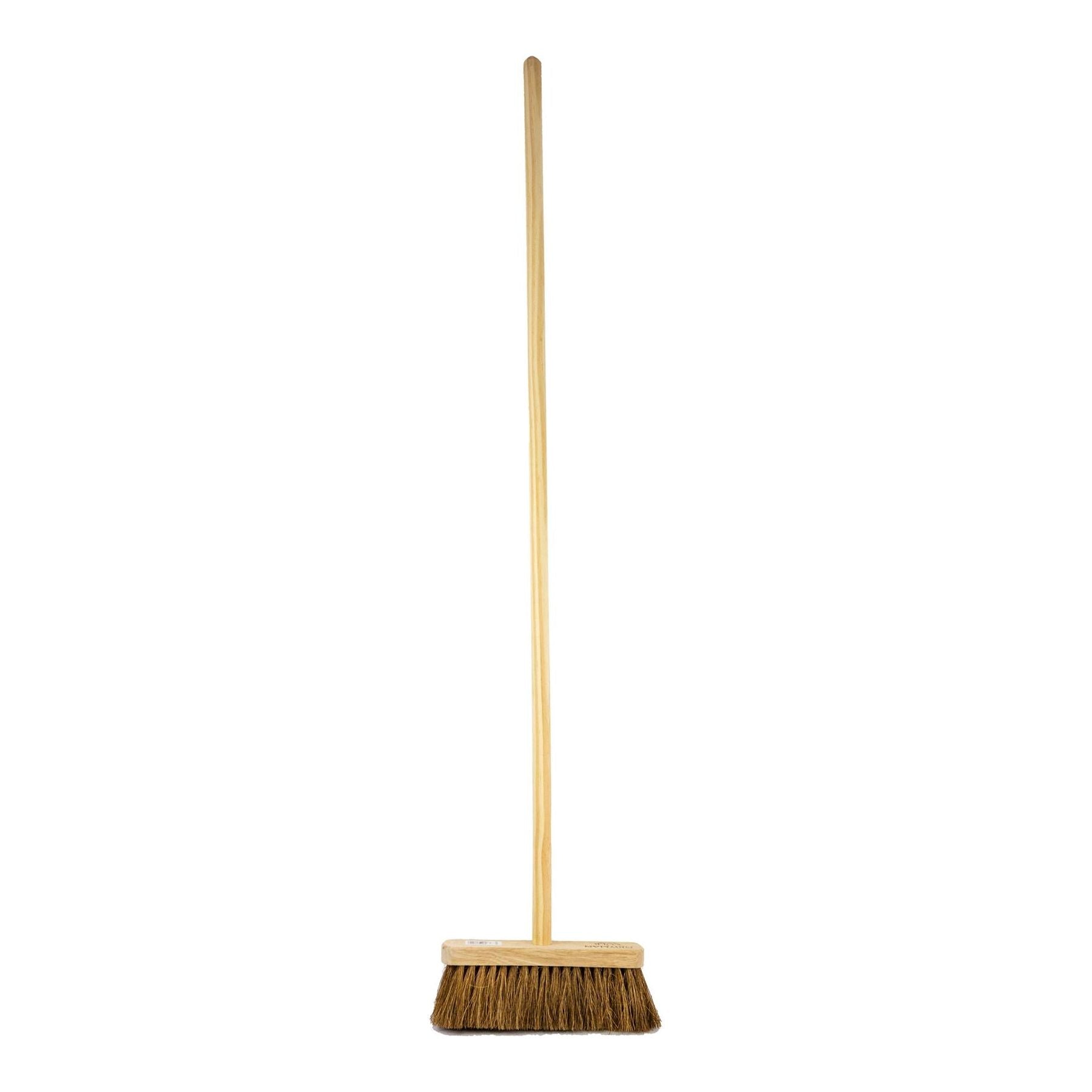 A traditional coco broom with a wooden handle and a 10-inch wide head featuring natural soft coco bristles, isolated on a white background.