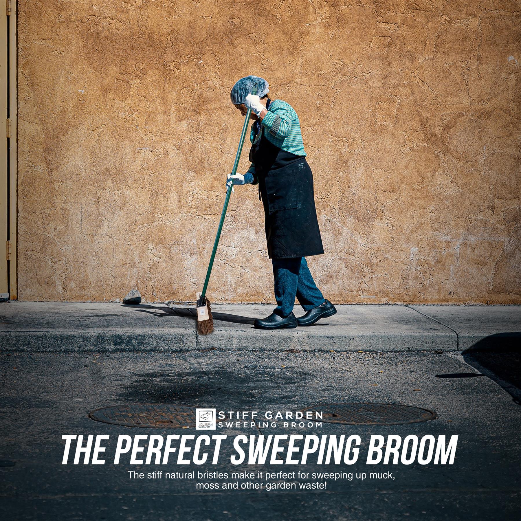 Action shot of a lady cleaning the street pavement with the 10" Stiff Bassine Broom with Metal Handle – Outdoor Yard Brush