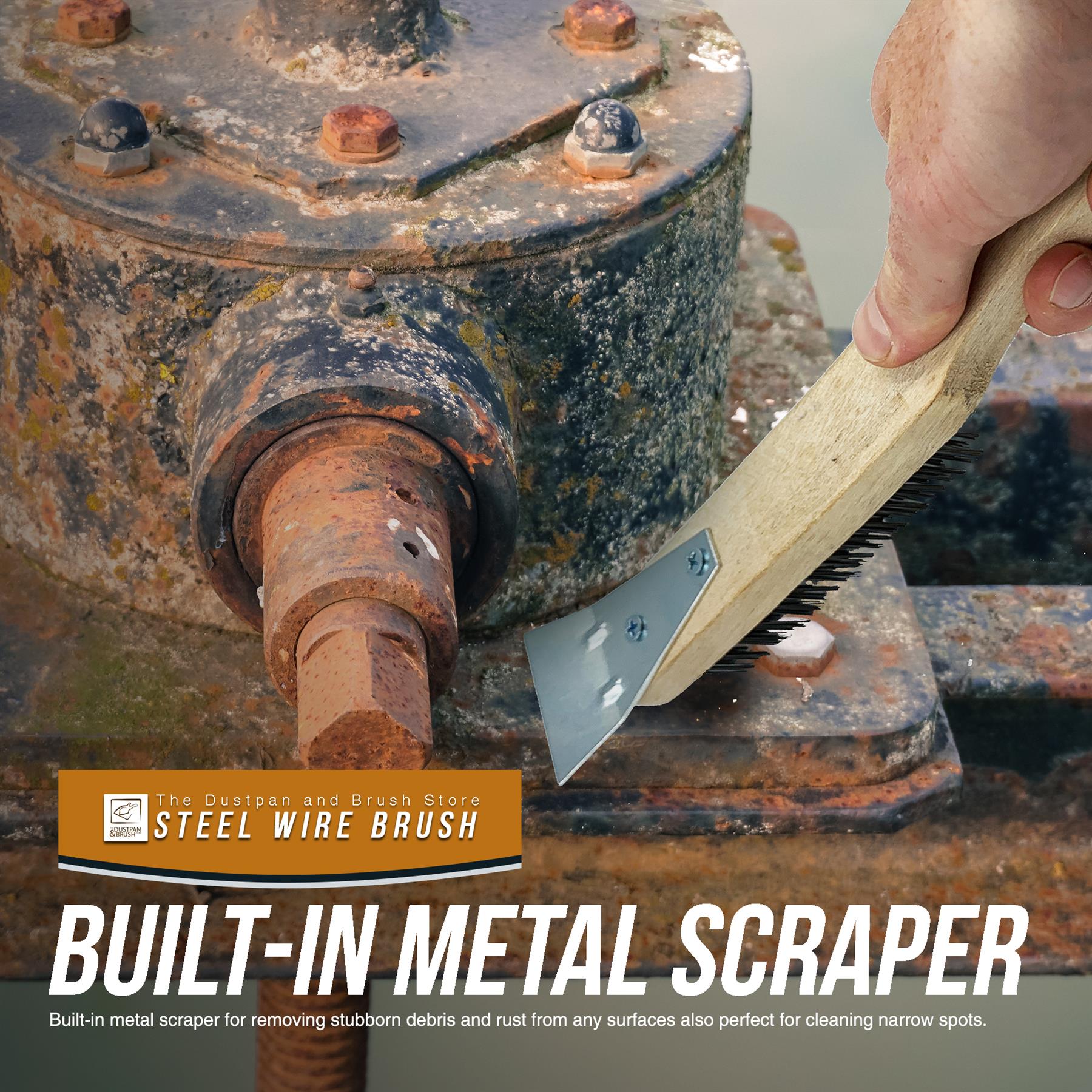 A hand holds a steel wire brush with a built in scraper against a rusty metal surface, with text reading 'BUILT-IN METAL SCRAPER'