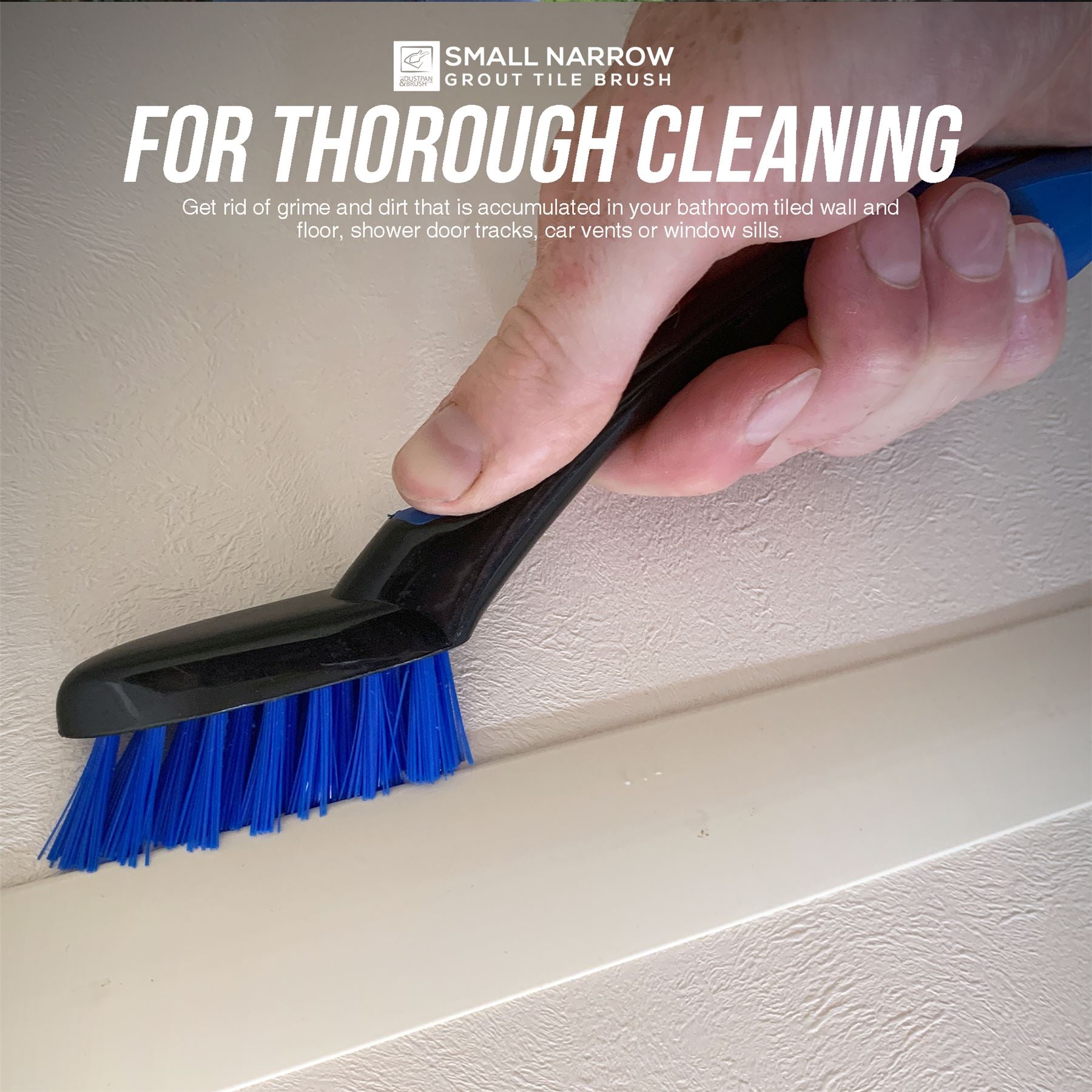 Small narrow grout tile brush with blue bristles being used to clean a corner.