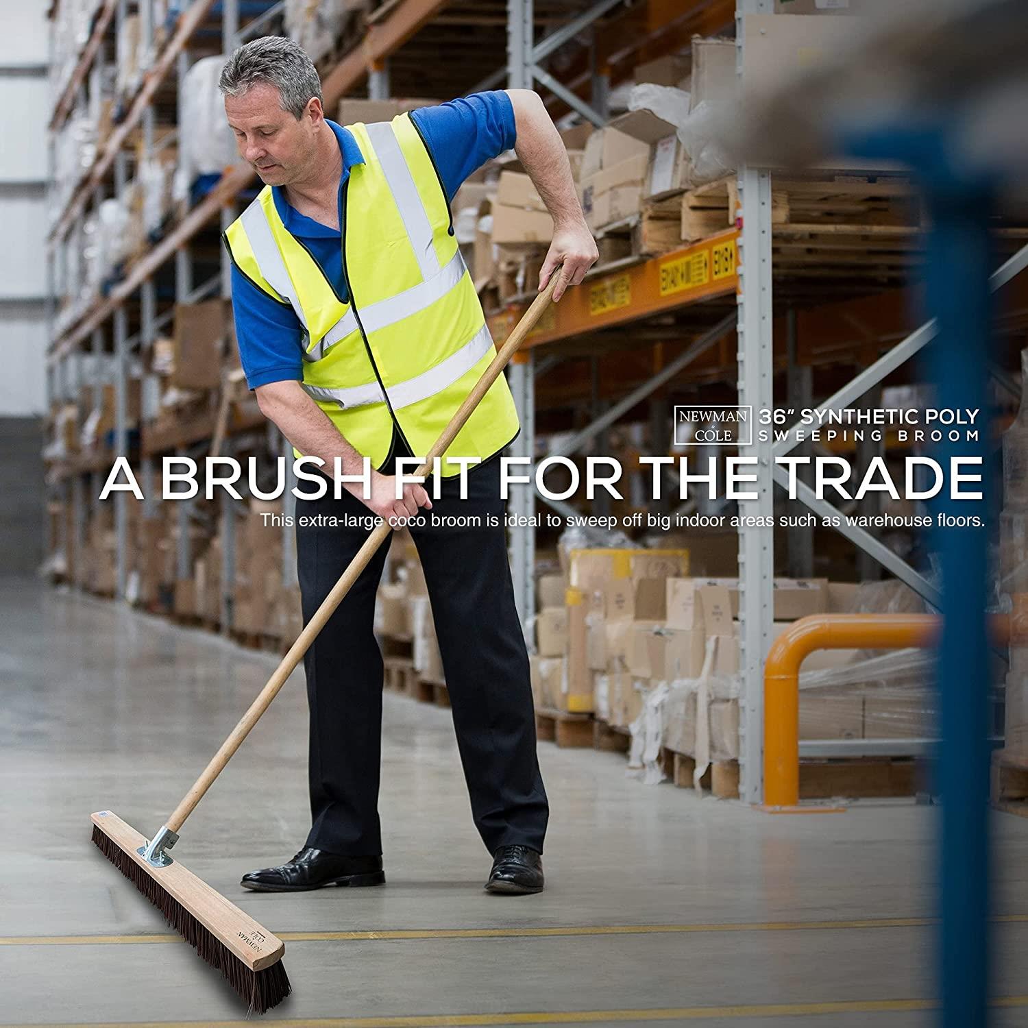 Man in warehouse using a broom with text about a synthetic poly broom.