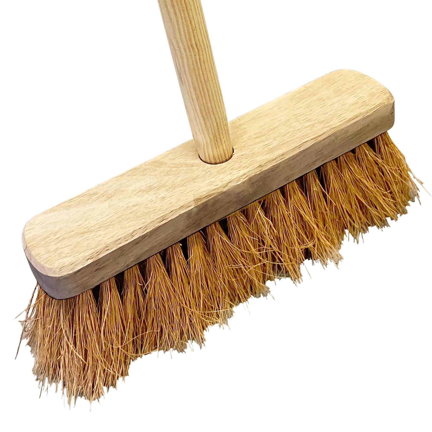 A traditional hand sweep broom with a light natural wood handle and a wide wooden head bristled with golden-brown straw fibers, shown on a plain white background.
