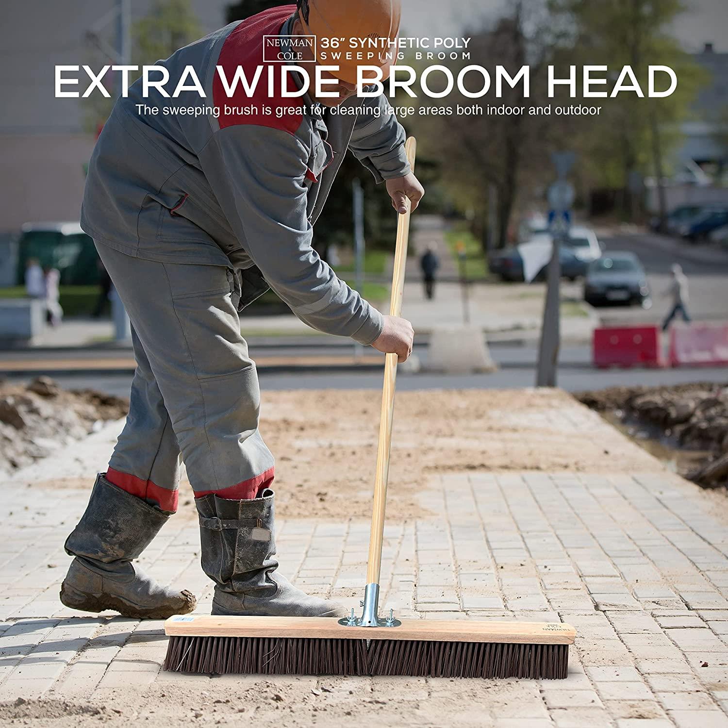 Person using a sweeping broom on a construction site with text about the broom's features.