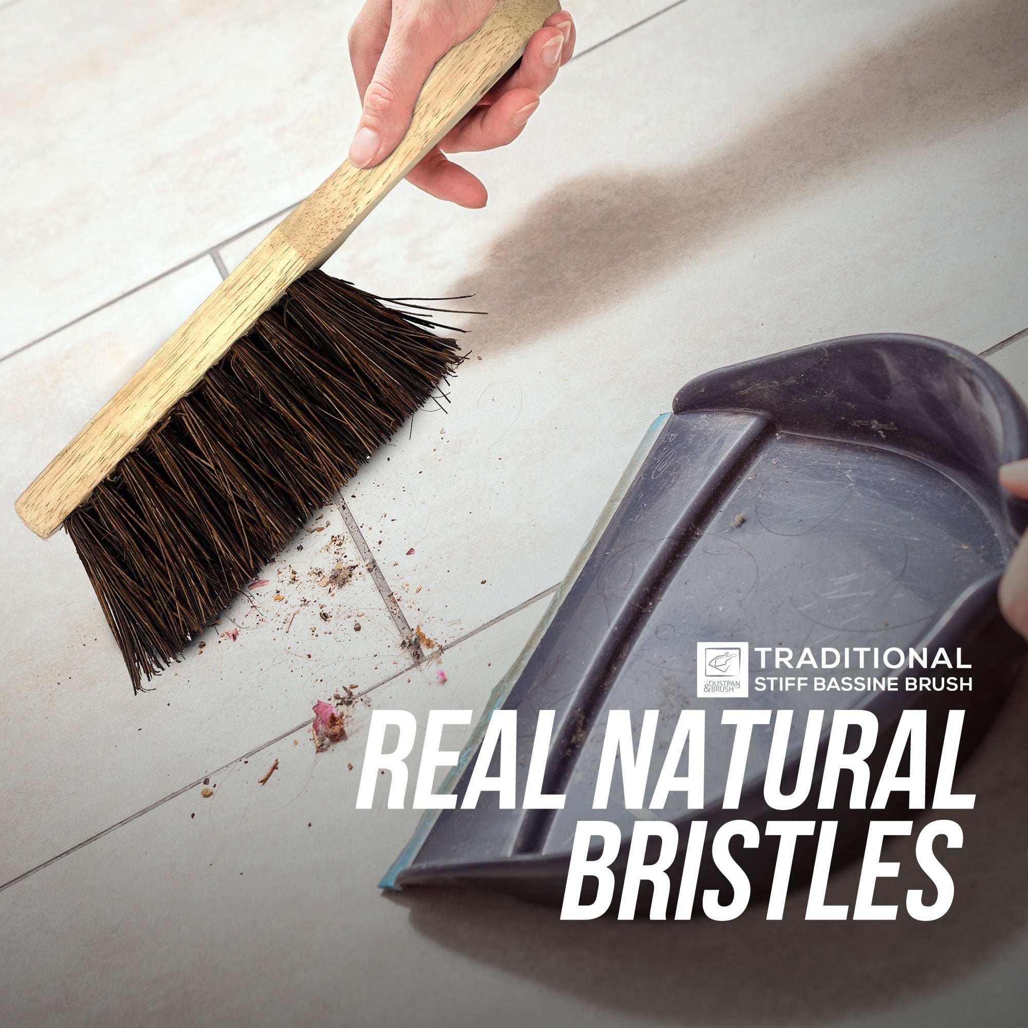 Hand using a broom with natural bristles to sweep up debris on a tiled floor, with a dustpan nearby. The text 'Real Natural Bristles' and 'Traditional Stiff Bascine Brush' is displayed.