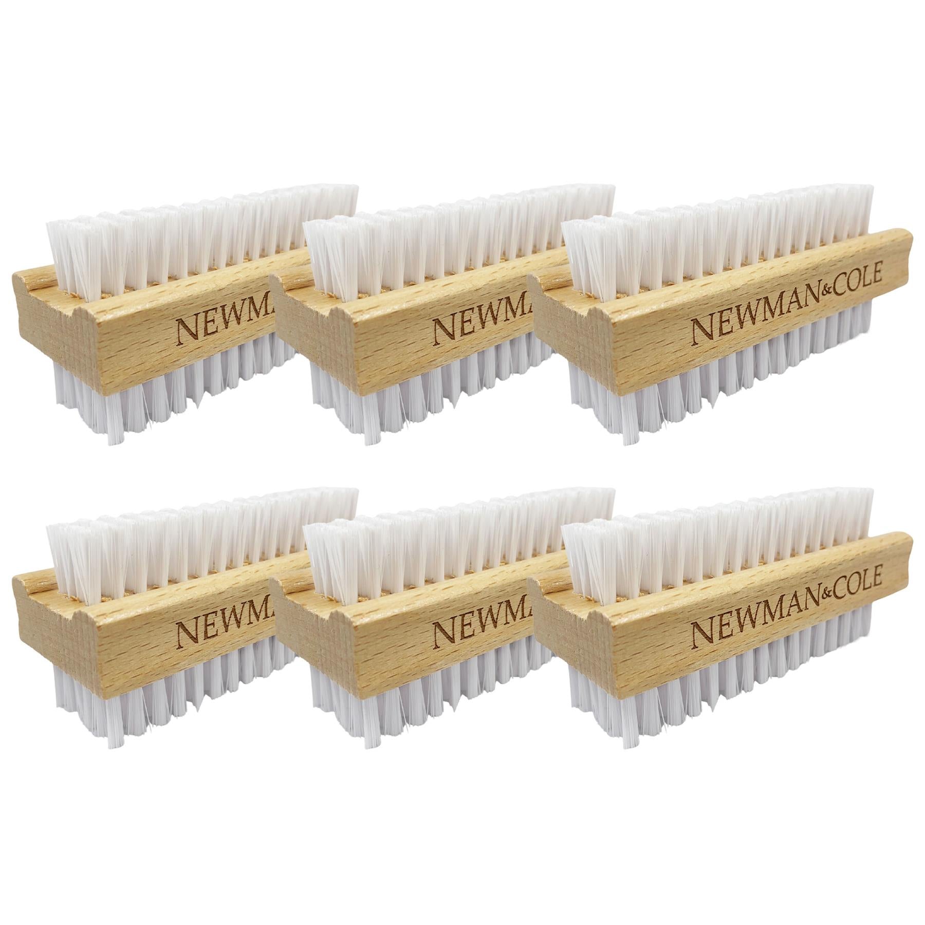 Six wooden cleaning brushes arranged in two rows of three on a white background. Each brush has a light natural wood handle engraved with 'NEWMAN & COLE'.