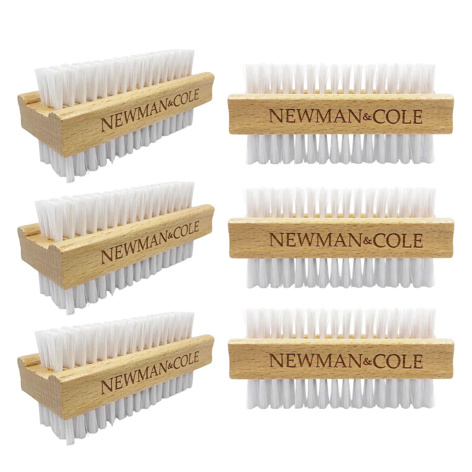 Six wooden hand brushes with white bristles, arranged in two columns on a plain white background. Each brush has a light natural wood handle engraved with the brand name 'NEWMAN&COLE'.