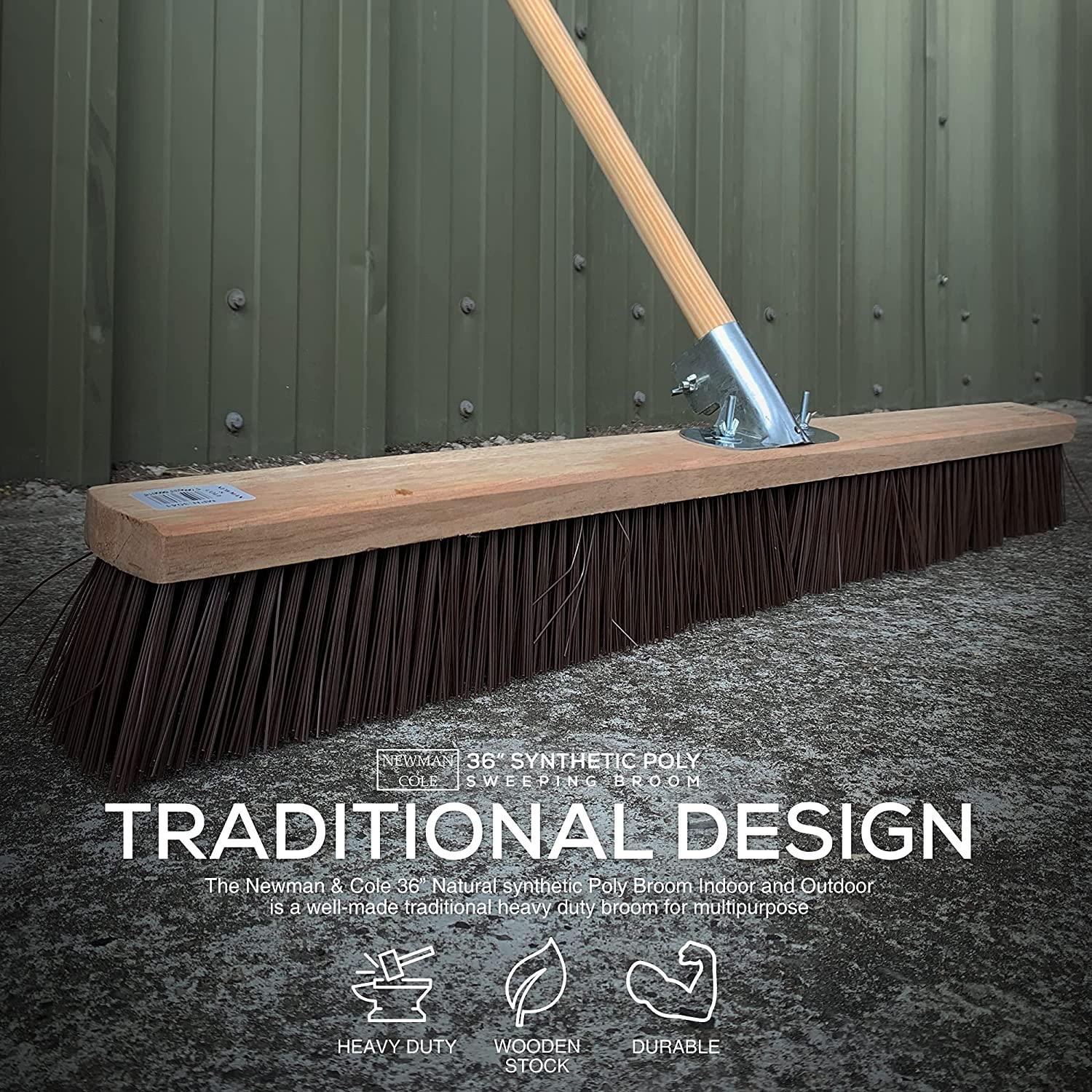 Newman & Cole 36-inch synthetic poly broom against a green metal wall.