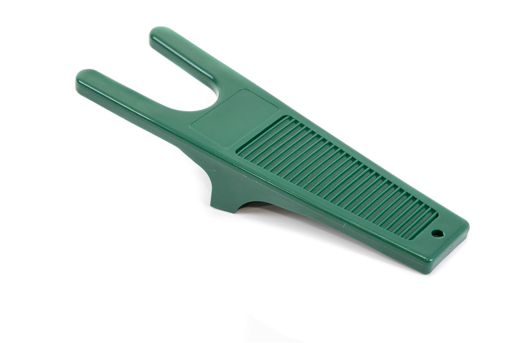 Green plastic boot jack on a white background