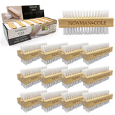 A set of wooden nail brushes arranged on a white background, with one larger brush shown at the top right and multiple smaller identical brushes below. The packaging box for Newman Cole wooden nail brushes is visible at the top left.