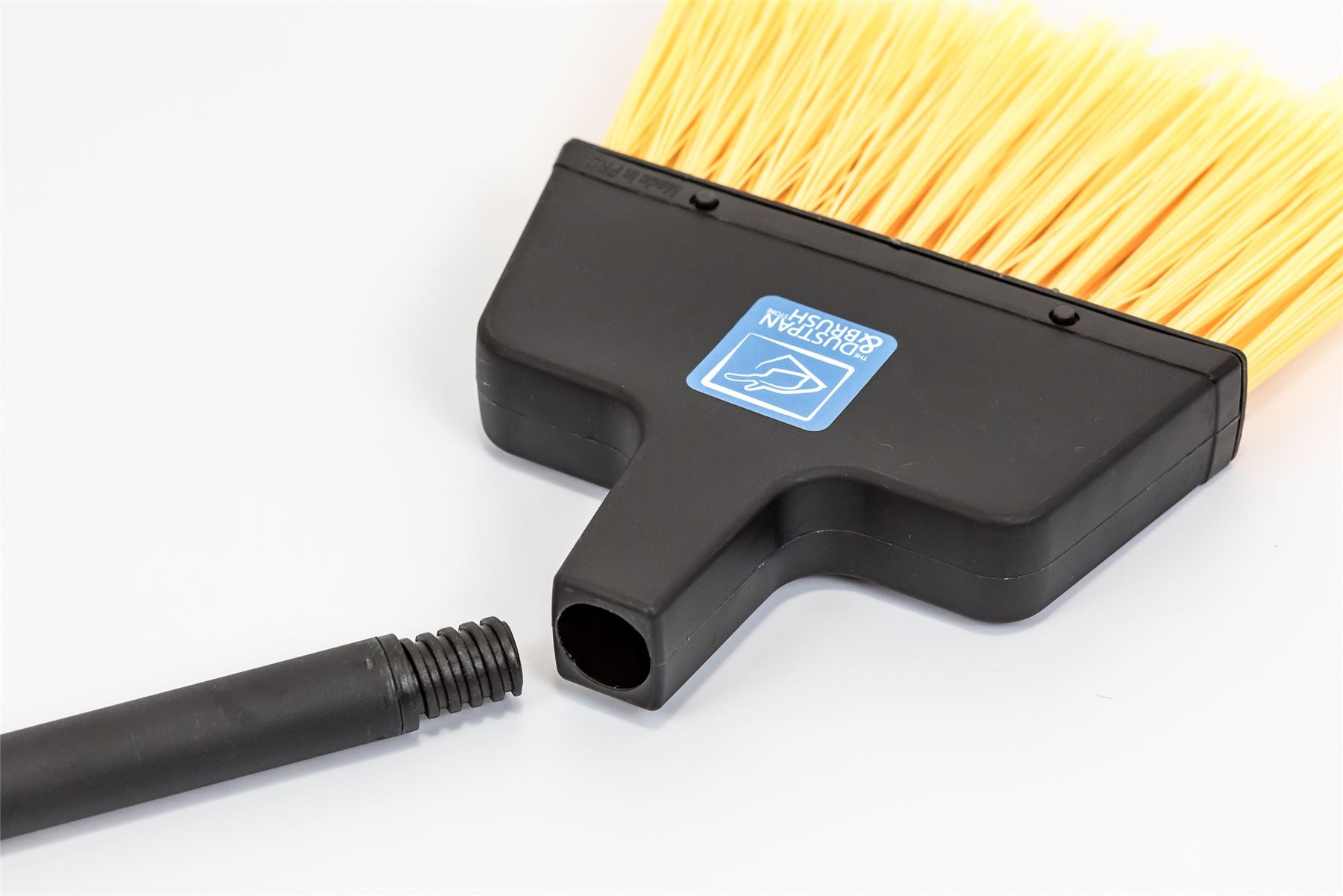 A black plastic broom head with bright yellow bristles and a detachable black handle, shown on a clean white background. A blue and white 'Wandora' brand sticker is visible on the side of the broom head.