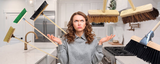 Promotional image of a woman confused on which broom to choose in her kitchen area