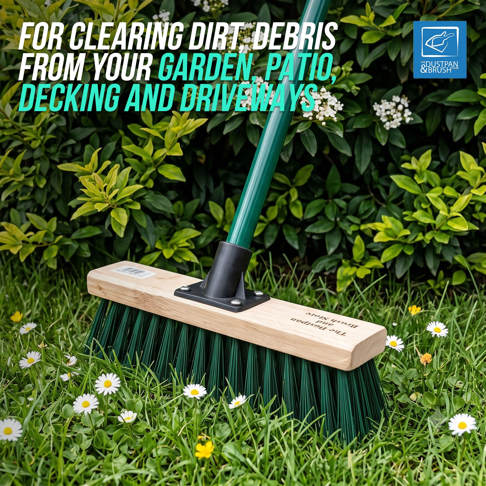 A green garden brush with a light wood handle and dark green bristles is shown in a grassy garden setting with white daisies and leafy green shrubs. Text at the top reads 'FOR CLEARING DIRT, DEBRIS FROM YOUR GARDEN, PATIO, DECKING AND DRIVEWAYS,' and a blue 'MOTION EDITION' logo appears in the top right.