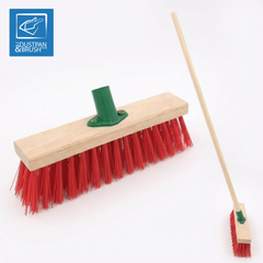 Image of 11.5" Stiff Red PVC Broom Head Stiff Outdoor Brush Head with Bracket with a handle in the bracket to show example of what it will look like 