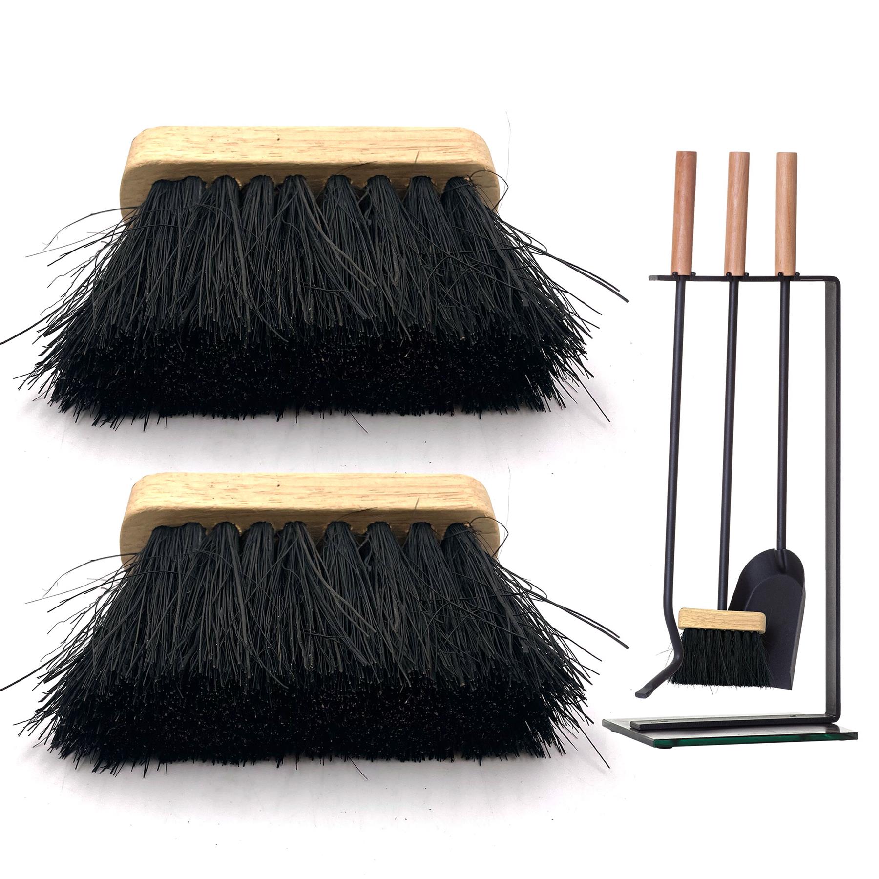Two black brush heads with light wood handles shown above a black metal fireplace tool set with matching wooden handles, dustpan, and brush on a white background.