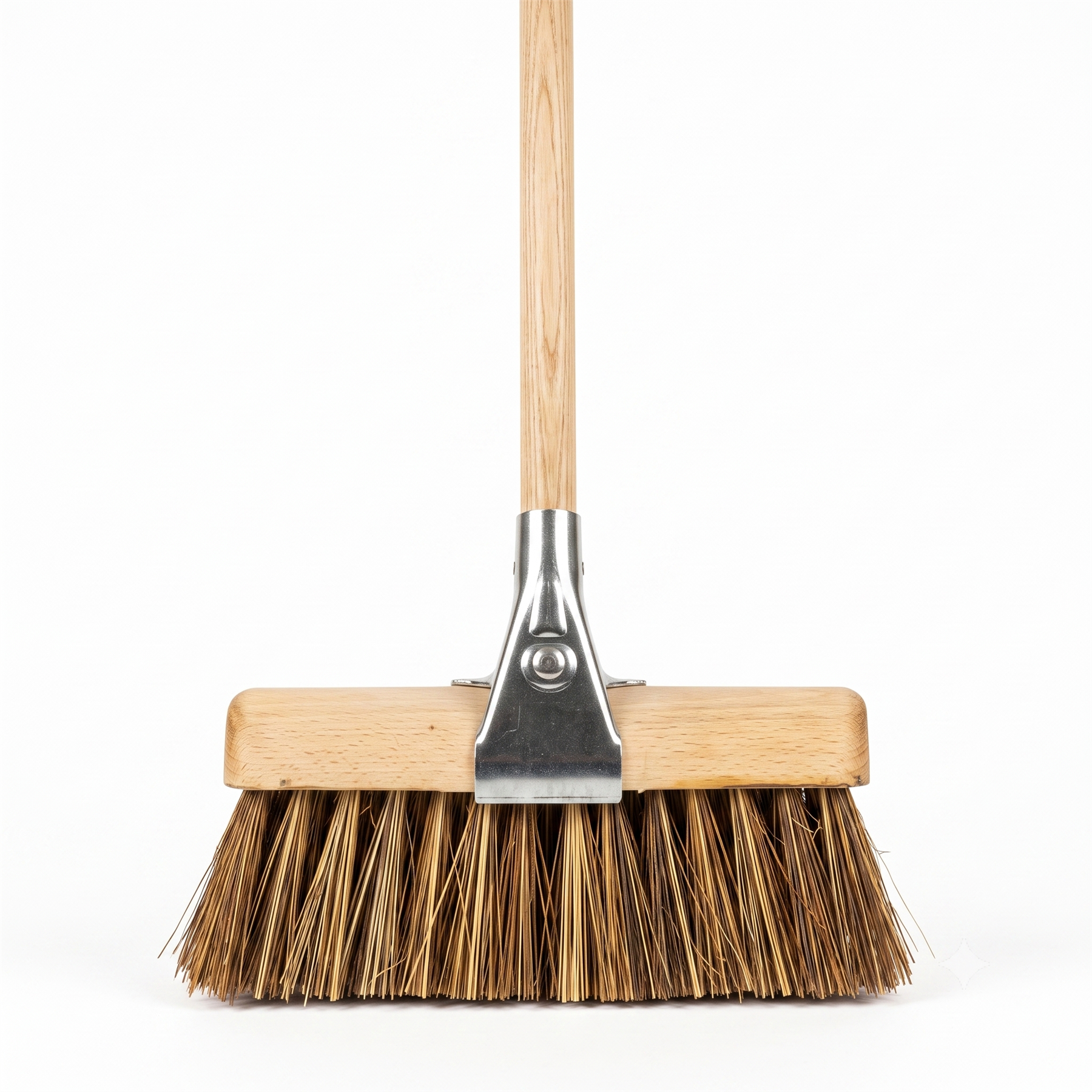 A traditional push broom with a light wood handle, a wooden head, and natural brown bass and cane bristles, featuring a silver metal connector.