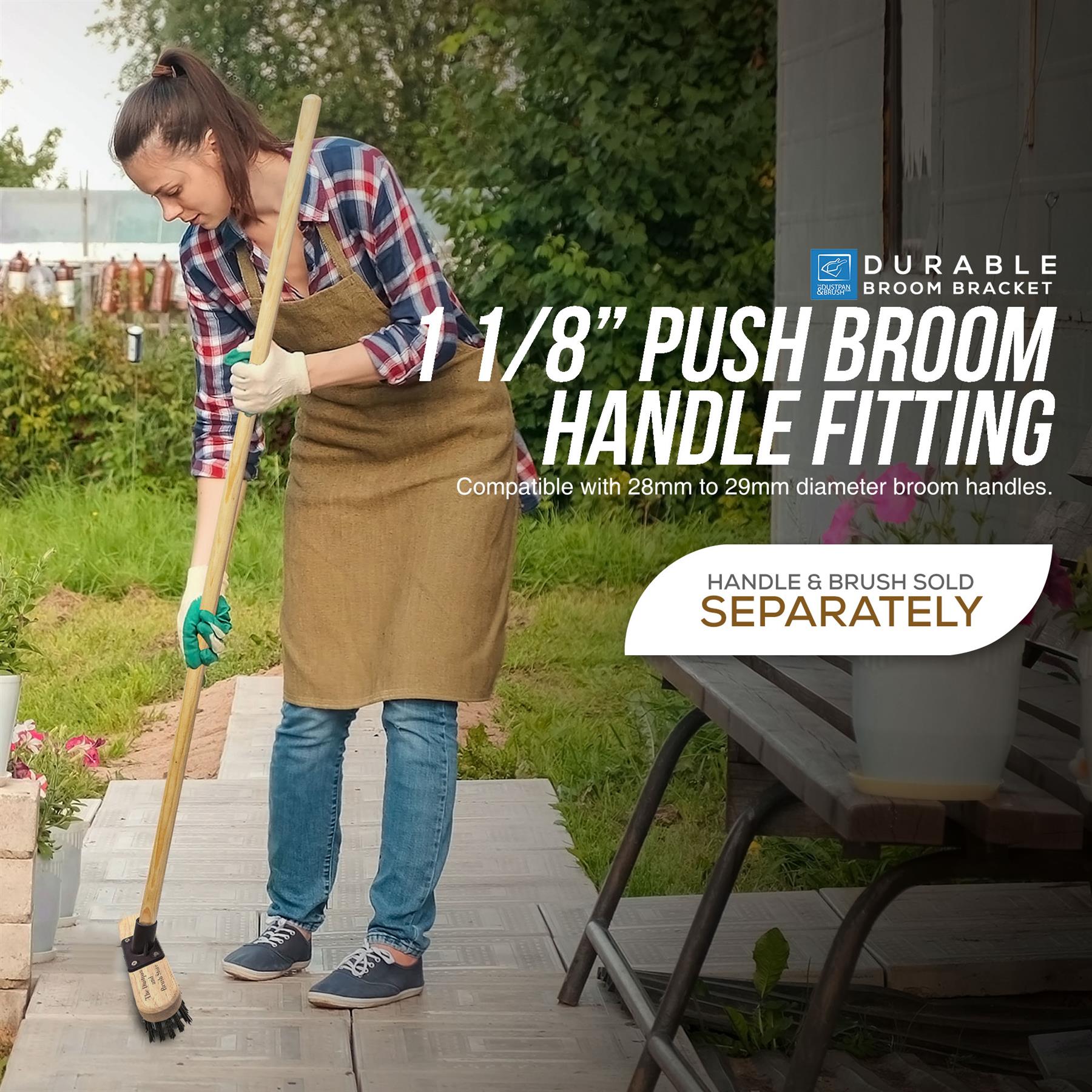 A woman in a plaid shirt and tan apron is sweeping a wooden deck with a long-handled push broom. Large text on the right reads '1 1/8" PUSH BROOM HANDLE FITTING' and 'HANDLE & BRUSH SOLD SEPARATELY,'.