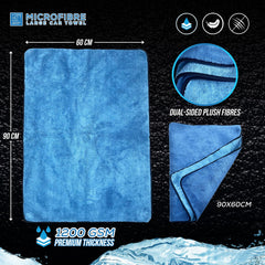 Blue microfibre large car towel shown on a black textured background with size measurements of 60 cm by 90 cm, a circular inset showing dual-sided plush fibres, and text noting 1200 GSM premium thickness.