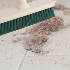 Close up shot of the Green Colour Coded 12" Soft Broom & Handle sweeping up dust off the floor 